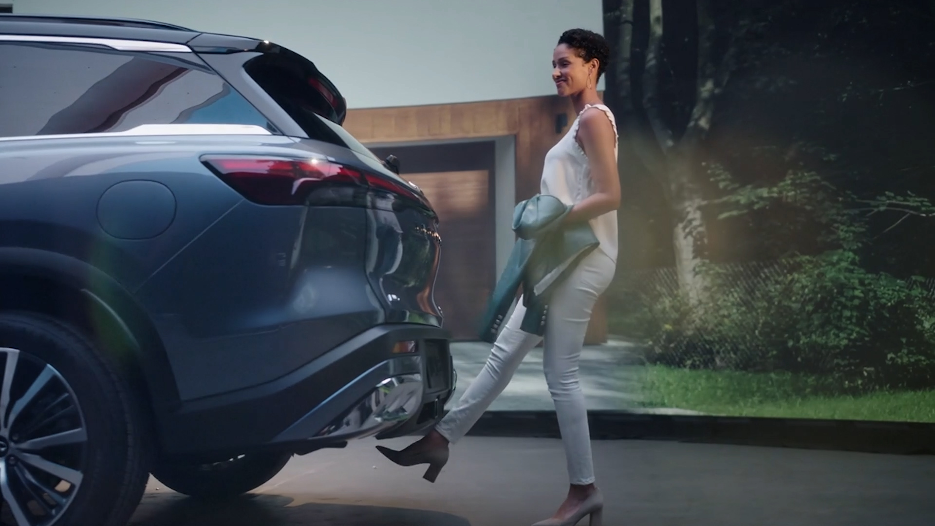 2022 INFINITI QX60 Crossover SUV parked with woman walking behind vehicle